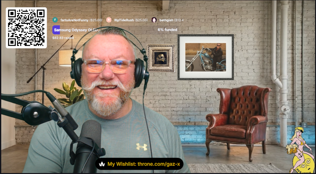 Gaz hosting a GAZ X live broadcast with headphones, microphone and studio background.